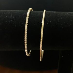 2 gold bangles, stone accent on one, twisted accent on other